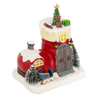 Aldeia bota de pai natal com luz, música e movimento